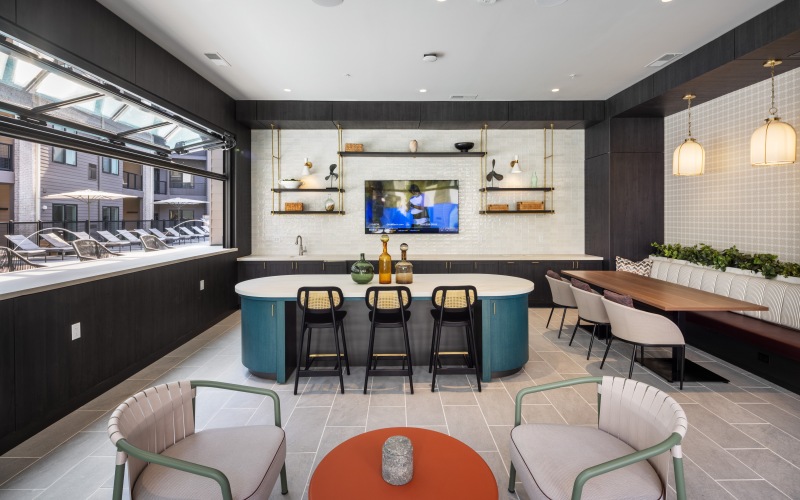open air room with tables and chairs overlooking the pool area
