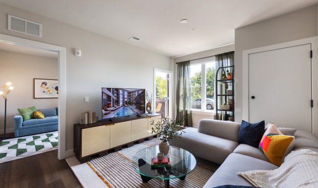 well lit living room with couch and TV