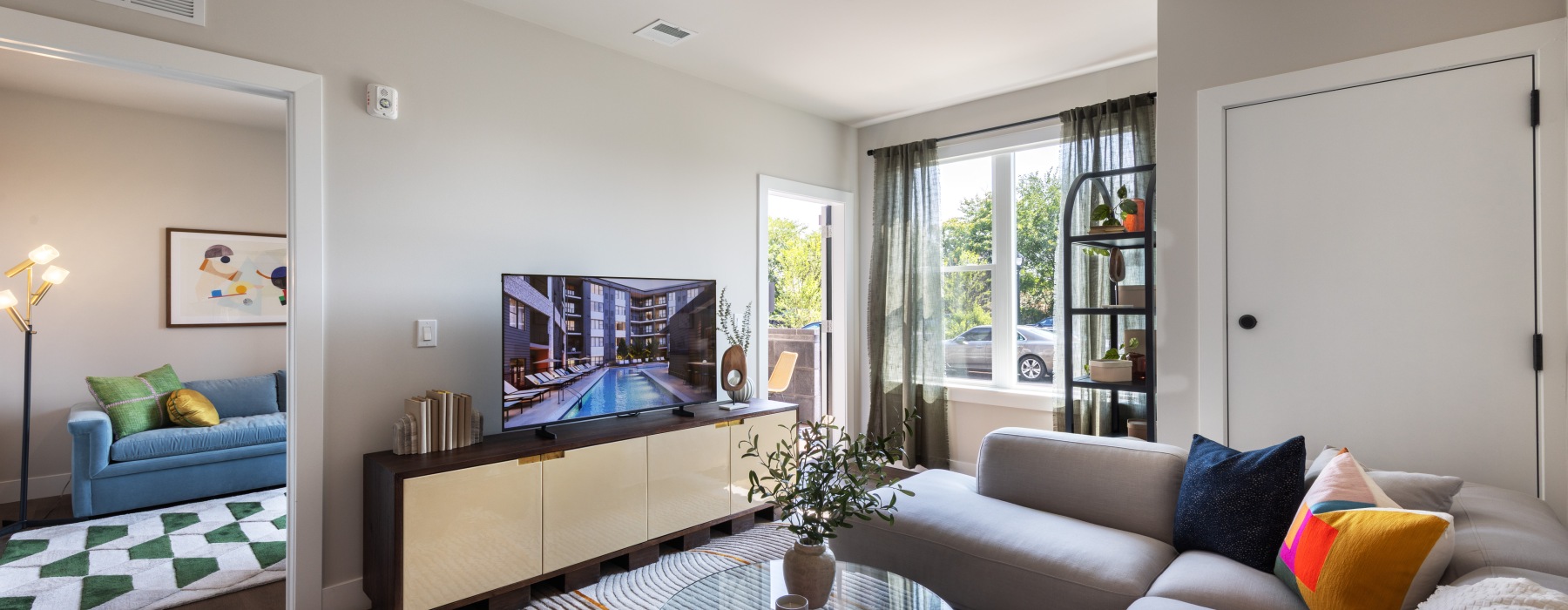 well lit living room with couch and TV