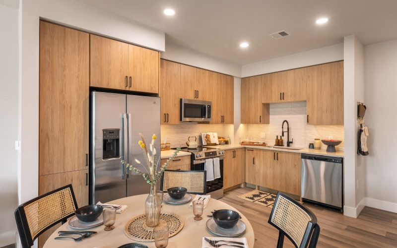 a kitchen with ample cabinets and space for a table and chairs